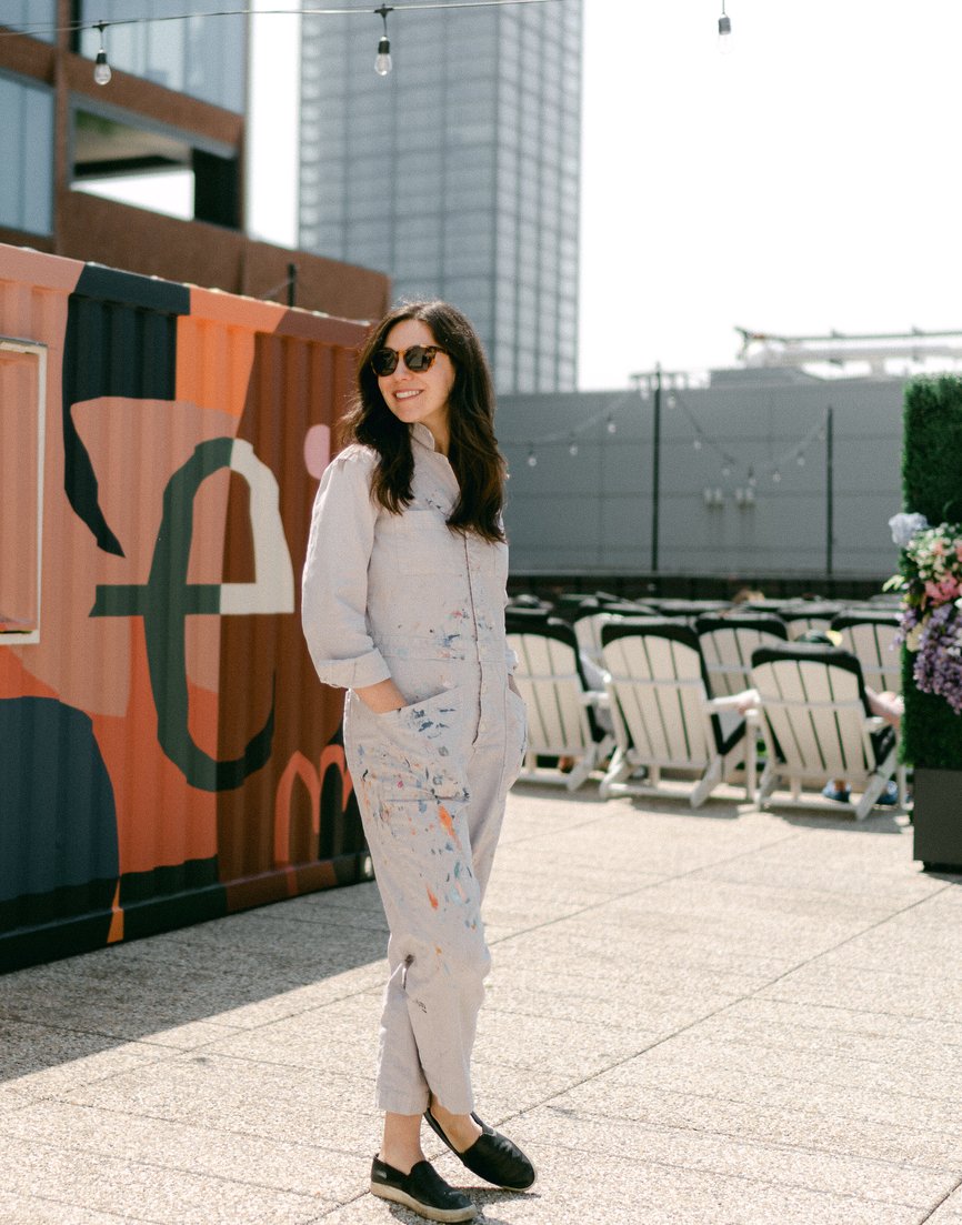 Emmy Star Brown standing in front of the shipping container she painted for the rooftop of The Emily Hotel