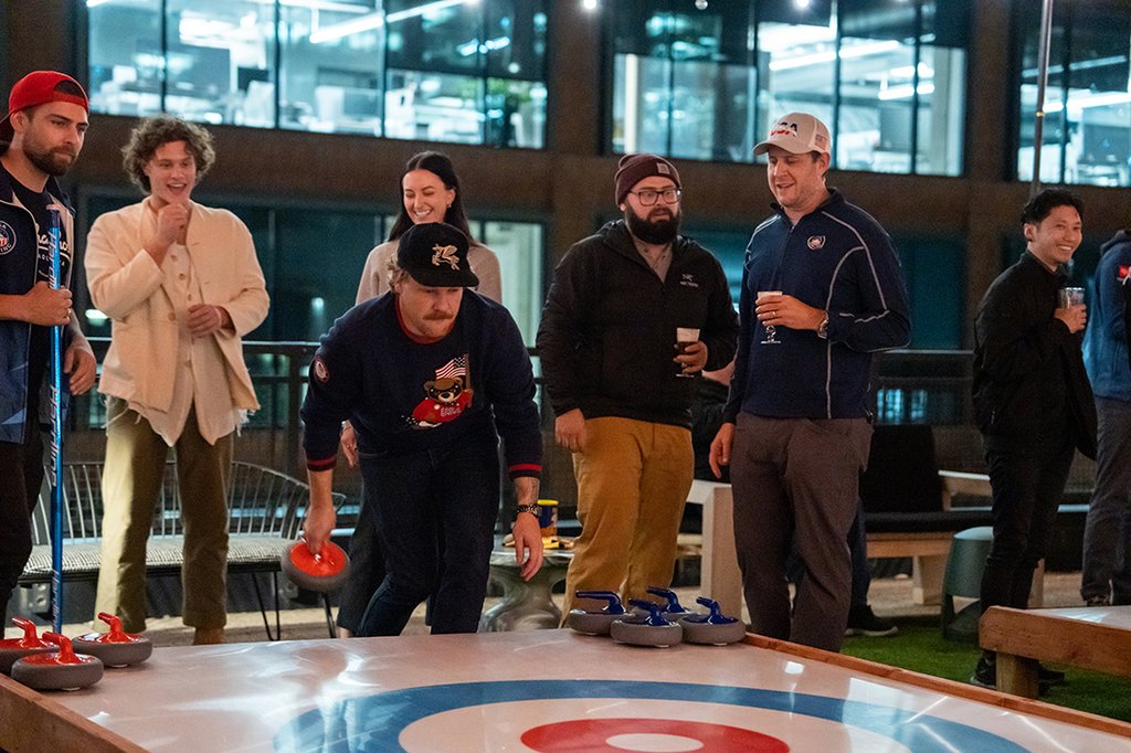 people participating in a curling match on the rooftop at the emily hotel fulton market chicago