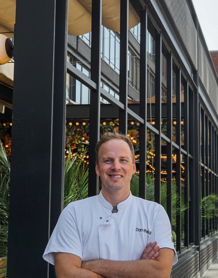 dan the baker pastry chef portrait in front of the emily hotel signage fulton market chicago