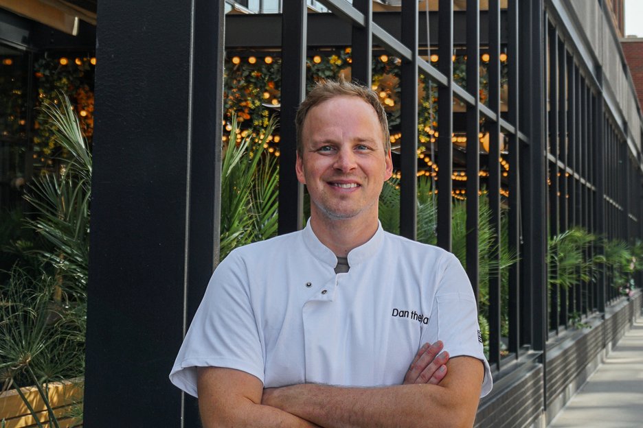dan the baker pastry chef portrait in front of the emily hotel signage fulton market chicago