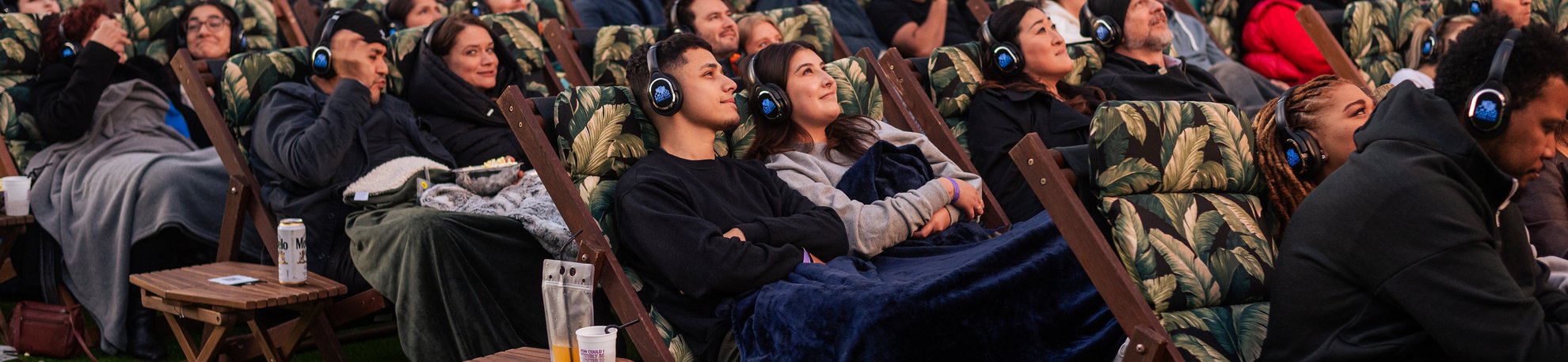 a bunch of people enjoying the movie screening rooftop cinema club fulton market at the emily hotel west loop